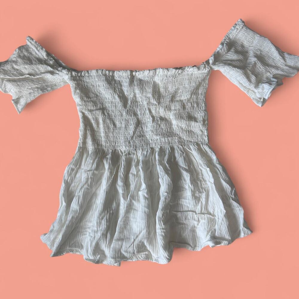 White smocked peplum puff off